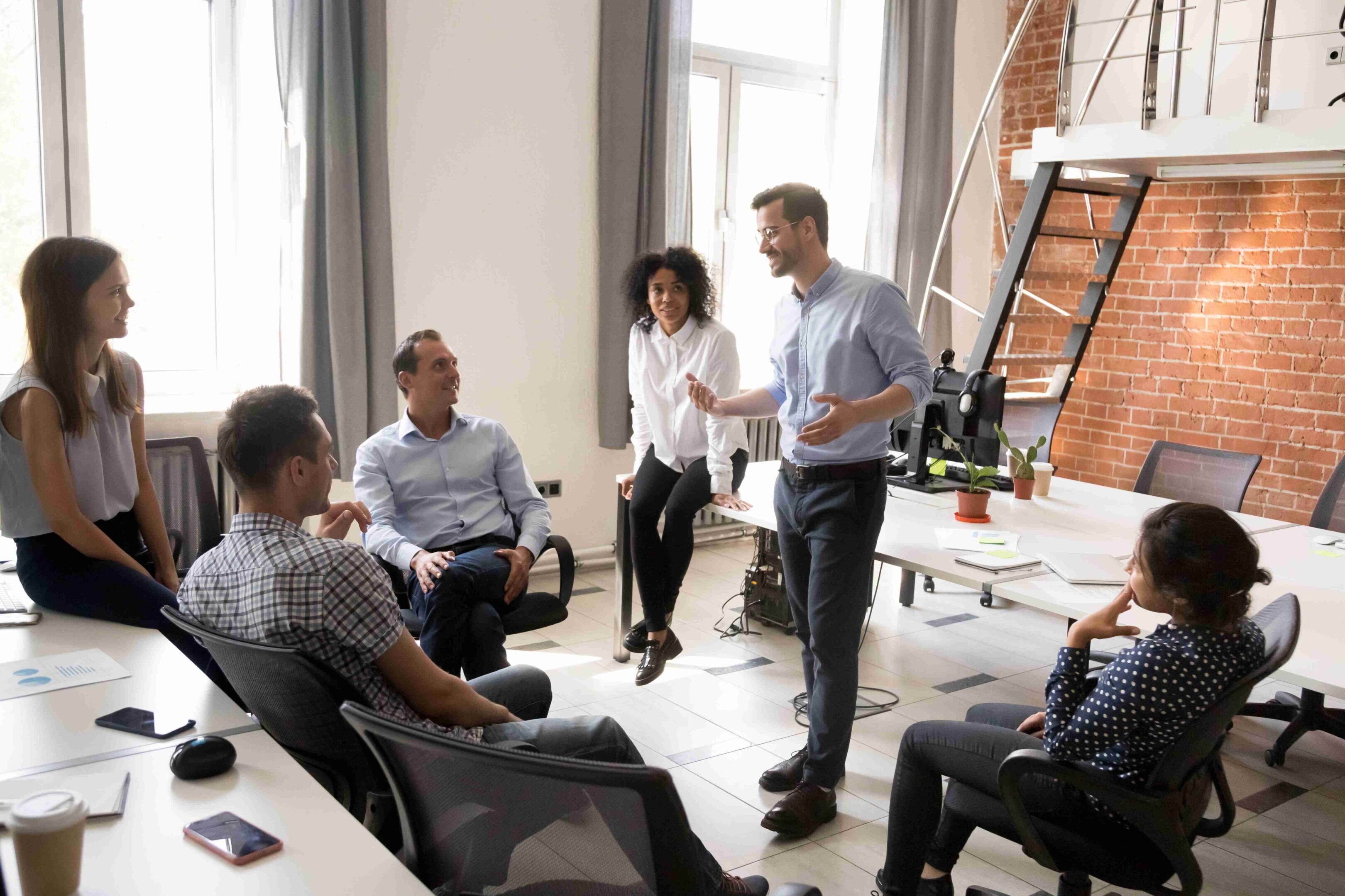 A team collaborates in a bright office space during a meeting.