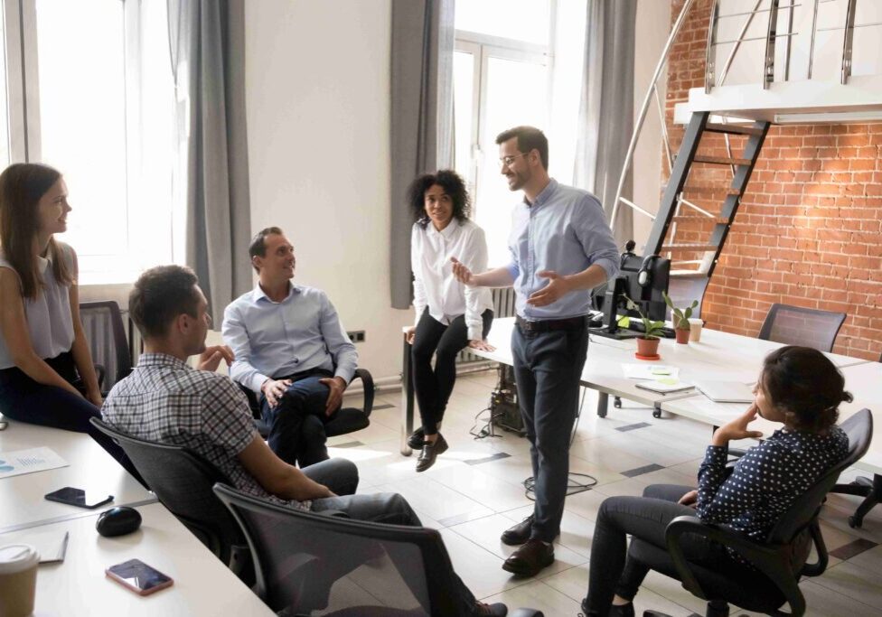 A team collaborates in a bright office space during a meeting.